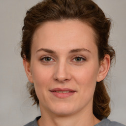 Joyful white young-adult female with medium  brown hair and blue eyes