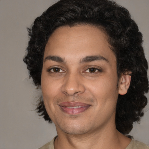 Joyful latino young-adult male with medium  black hair and brown eyes