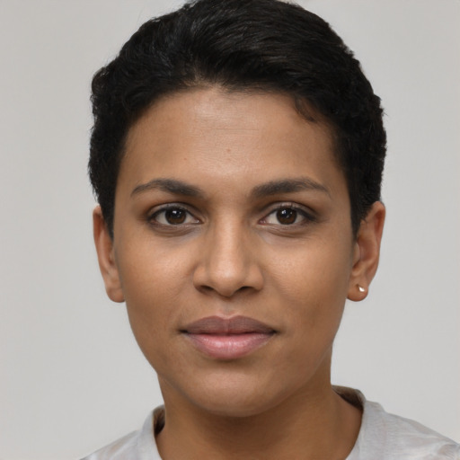 Joyful latino young-adult female with short  black hair and brown eyes