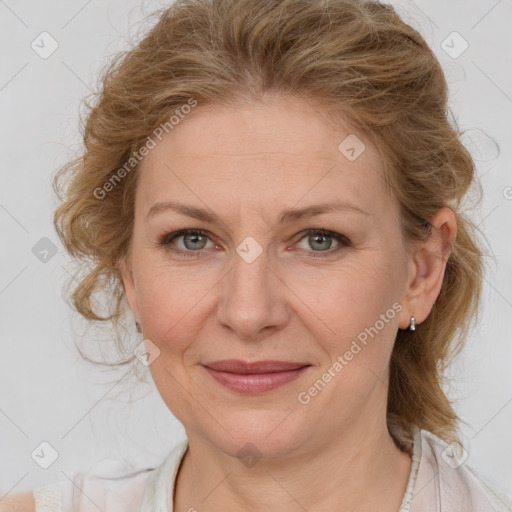 Joyful white adult female with medium  brown hair and blue eyes