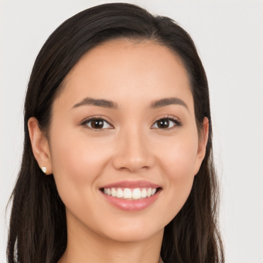 Joyful white young-adult female with long  brown hair and brown eyes