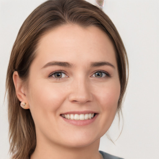 Joyful white young-adult female with long  brown hair and grey eyes