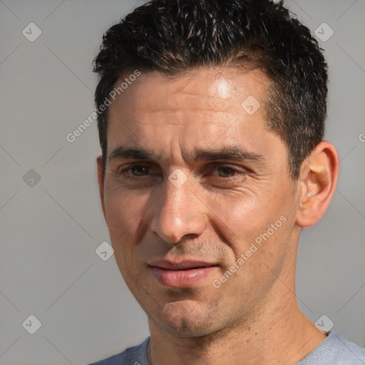 Joyful white adult male with short  black hair and brown eyes