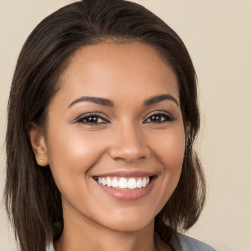 Joyful white young-adult female with long  brown hair and brown eyes