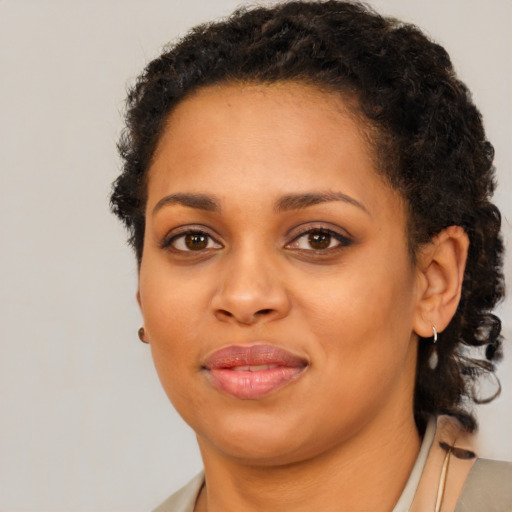 Joyful black young-adult female with short  brown hair and brown eyes