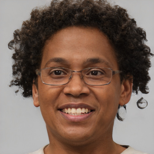 Joyful black adult female with short  brown hair and brown eyes