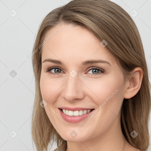 Joyful white young-adult female with long  brown hair and grey eyes