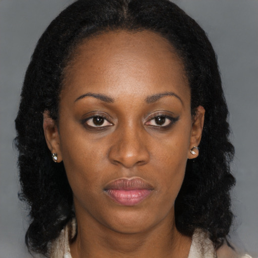 Neutral black young-adult female with long  brown hair and brown eyes