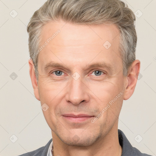 Joyful white adult male with short  brown hair and grey eyes