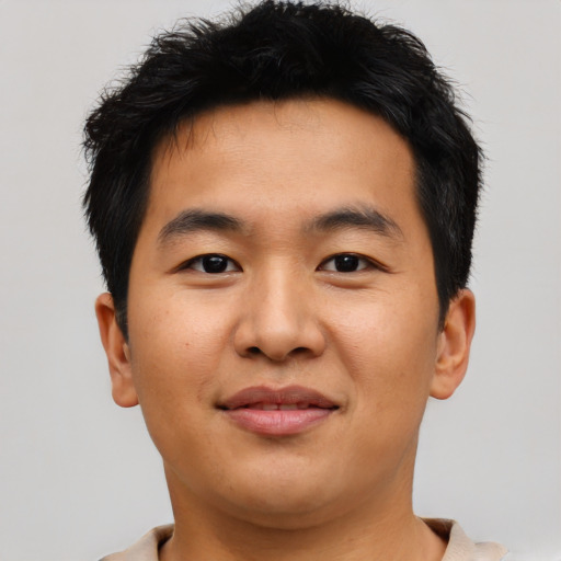 Joyful asian young-adult male with short  brown hair and brown eyes