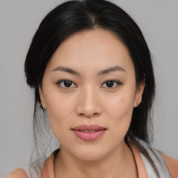 Joyful asian young-adult female with medium  black hair and brown eyes