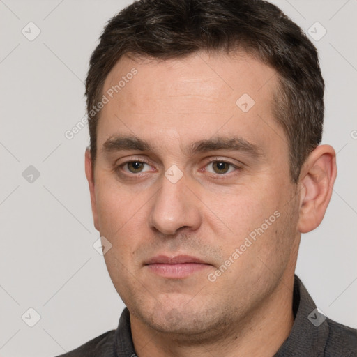 Joyful white adult male with short  brown hair and brown eyes