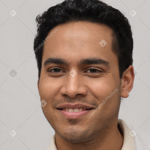 Joyful latino young-adult male with short  black hair and brown eyes