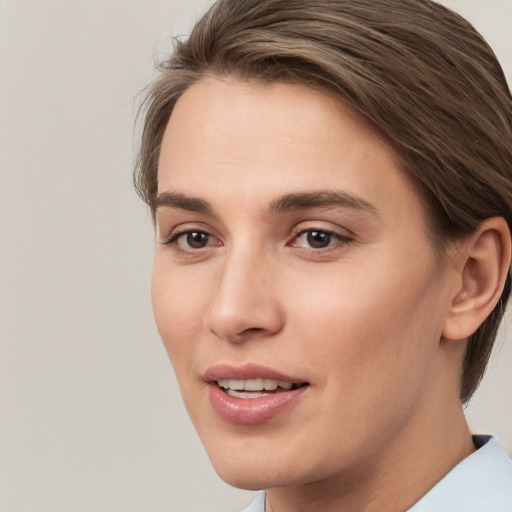 Joyful white young-adult female with short  brown hair and brown eyes