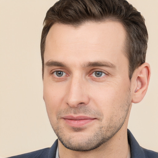 Joyful white young-adult male with short  brown hair and brown eyes