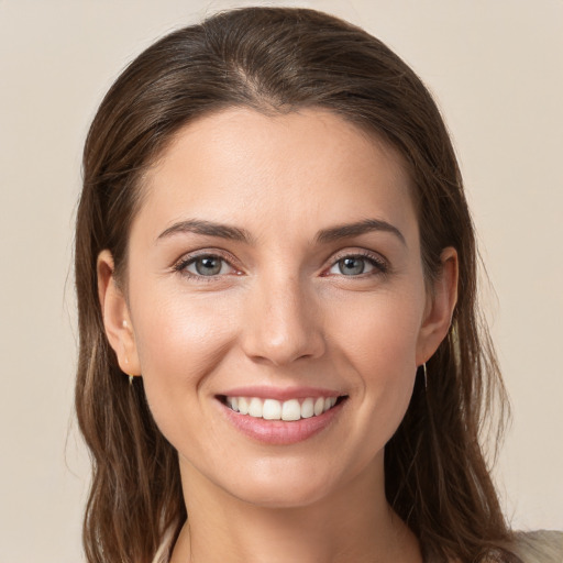 Joyful white young-adult female with long  brown hair and grey eyes