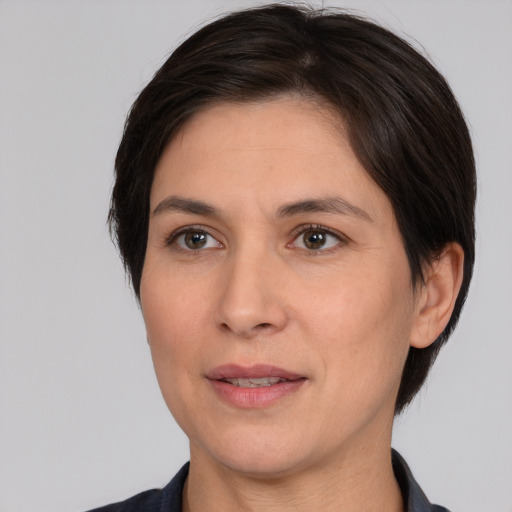 Joyful white adult female with medium  brown hair and brown eyes