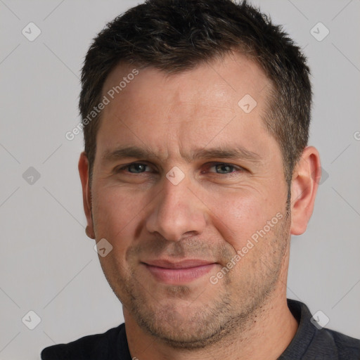 Joyful white adult male with short  brown hair and brown eyes