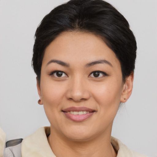 Joyful asian young-adult female with short  brown hair and brown eyes