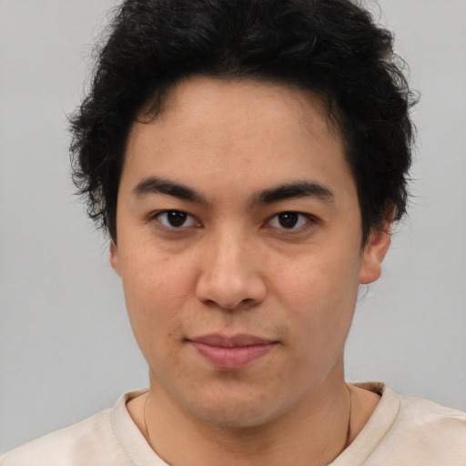 Joyful latino young-adult male with short  brown hair and brown eyes