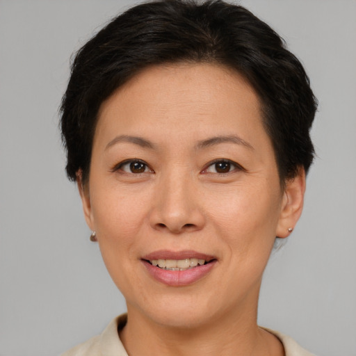 Joyful asian adult female with short  brown hair and brown eyes