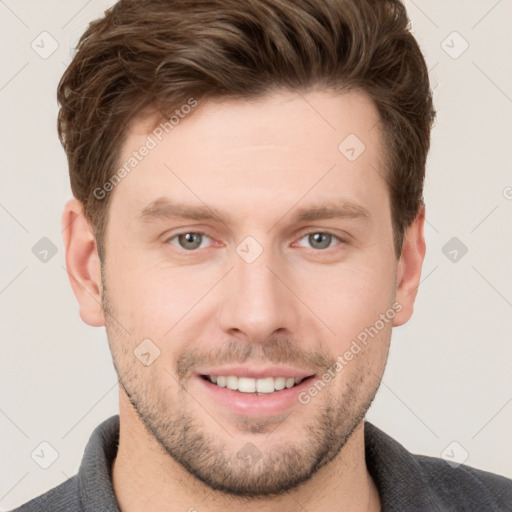 Joyful white young-adult male with short  brown hair and grey eyes