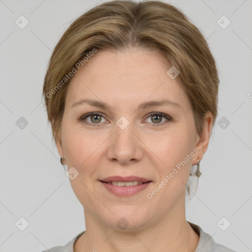 Joyful white adult female with medium  brown hair and grey eyes