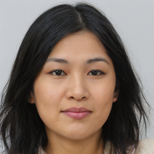 Joyful asian young-adult female with long  black hair and brown eyes
