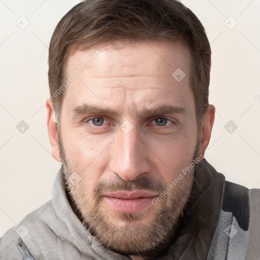 Joyful white adult male with short  brown hair and grey eyes