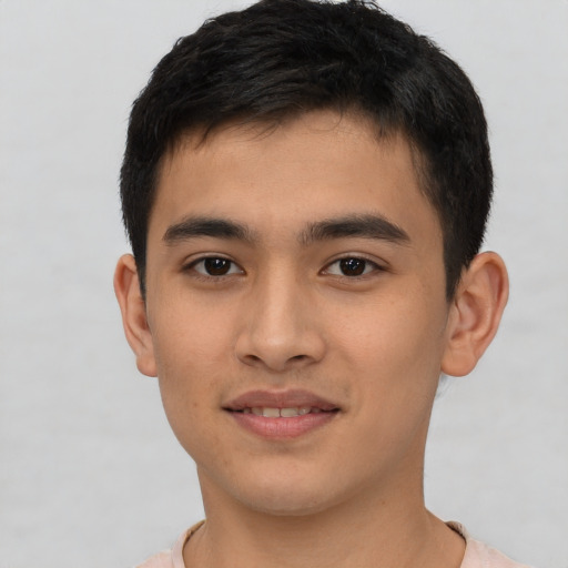 Joyful latino young-adult male with short  brown hair and brown eyes