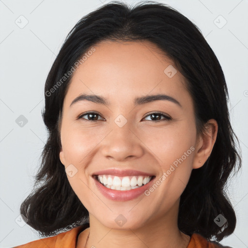 Joyful latino young-adult female with medium  brown hair and brown eyes