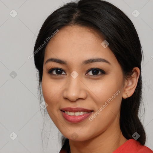 Joyful latino young-adult female with long  black hair and brown eyes