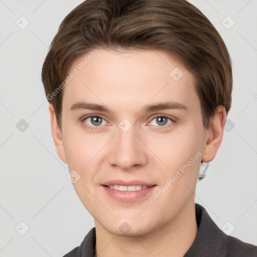 Joyful white young-adult male with short  brown hair and grey eyes