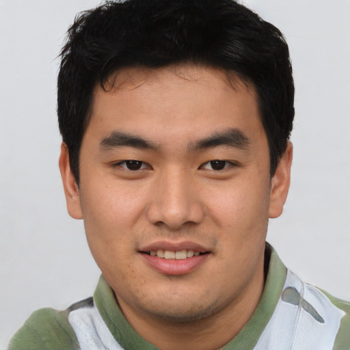 Joyful asian young-adult male with short  brown hair and brown eyes