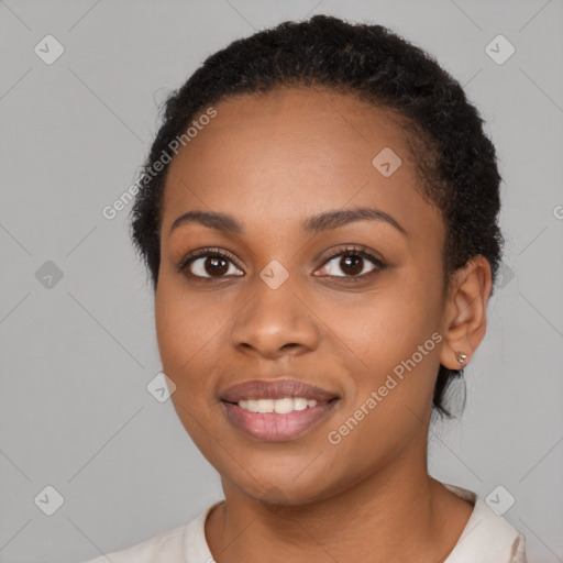 Joyful black young-adult female with short  black hair and brown eyes