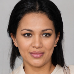 Joyful latino young-adult female with medium  brown hair and brown eyes