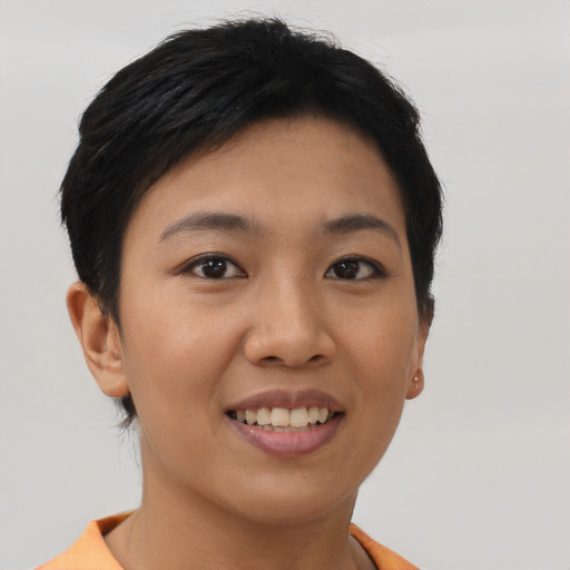 Joyful asian young-adult female with short  brown hair and brown eyes
