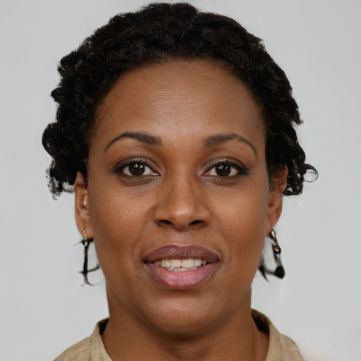 Joyful black adult female with short  brown hair and brown eyes