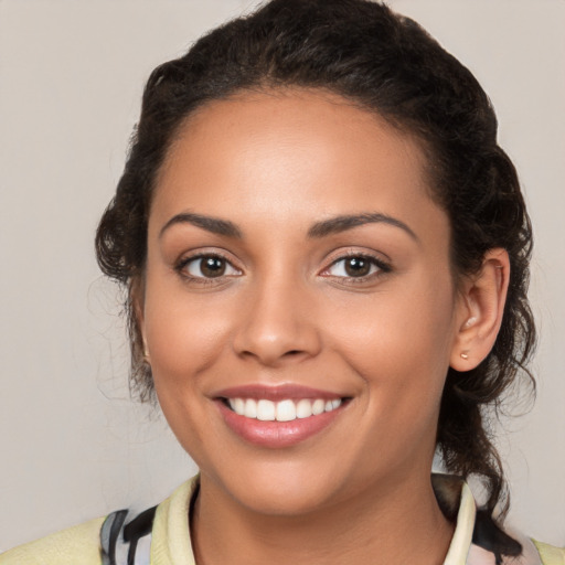 Joyful latino young-adult female with medium  brown hair and brown eyes