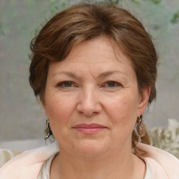 Joyful white adult female with medium  brown hair and blue eyes