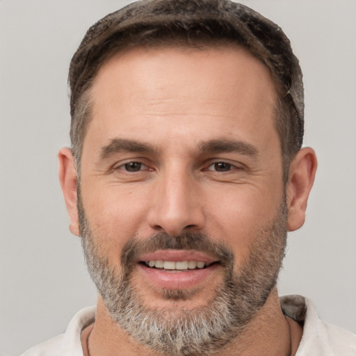 Joyful white adult male with short  brown hair and brown eyes