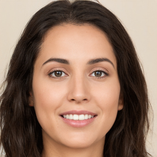 Joyful white young-adult female with long  brown hair and brown eyes