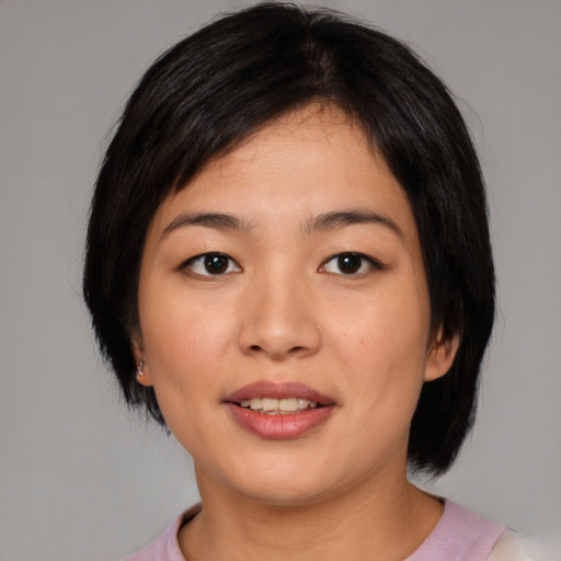 Joyful asian young-adult female with medium  black hair and brown eyes