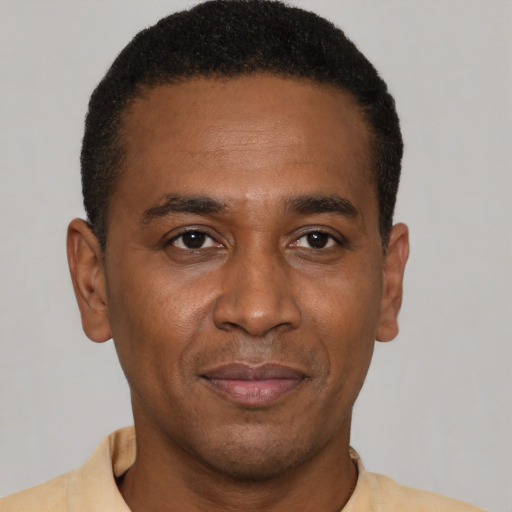 Joyful latino adult male with short  black hair and brown eyes