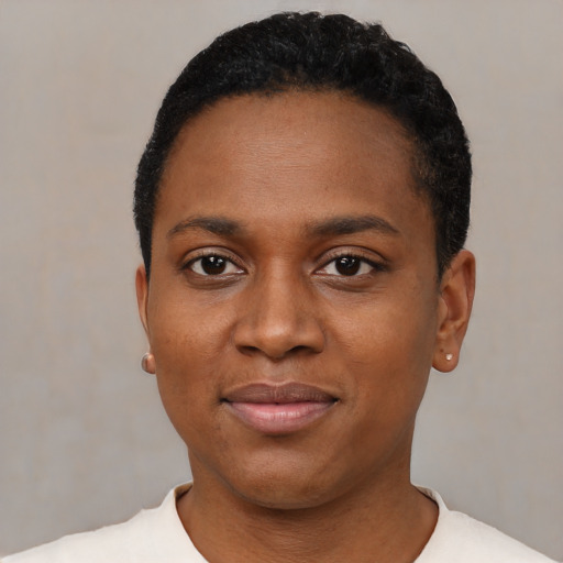 Joyful black young-adult female with short  black hair and brown eyes