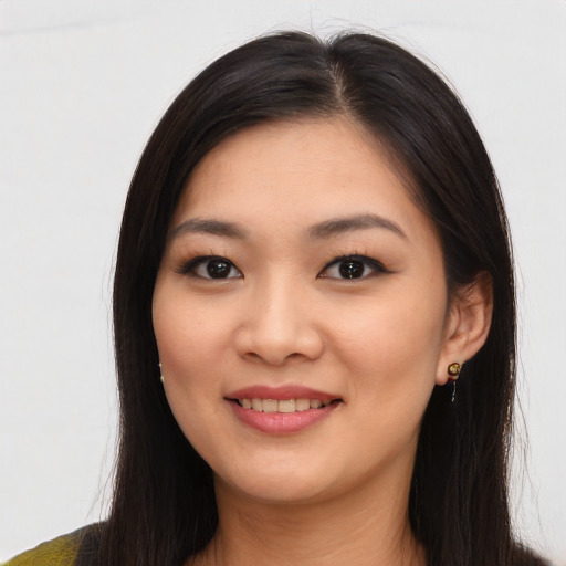 Joyful asian young-adult female with long  brown hair and brown eyes