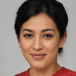 Joyful latino young-adult female with medium  brown hair and brown eyes