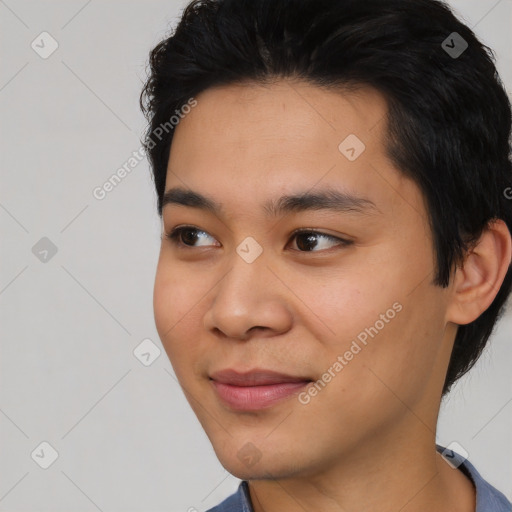 Joyful asian young-adult male with short  black hair and brown eyes