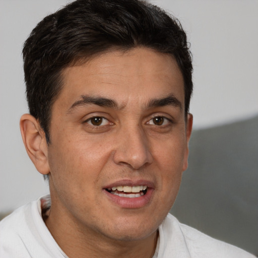 Joyful white adult male with short  brown hair and brown eyes