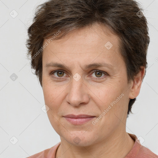 Joyful white adult female with short  brown hair and brown eyes